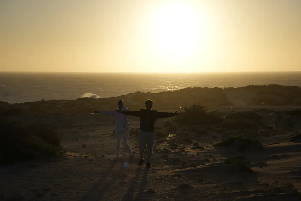 Two figures on a ridge at sunset, Morocco